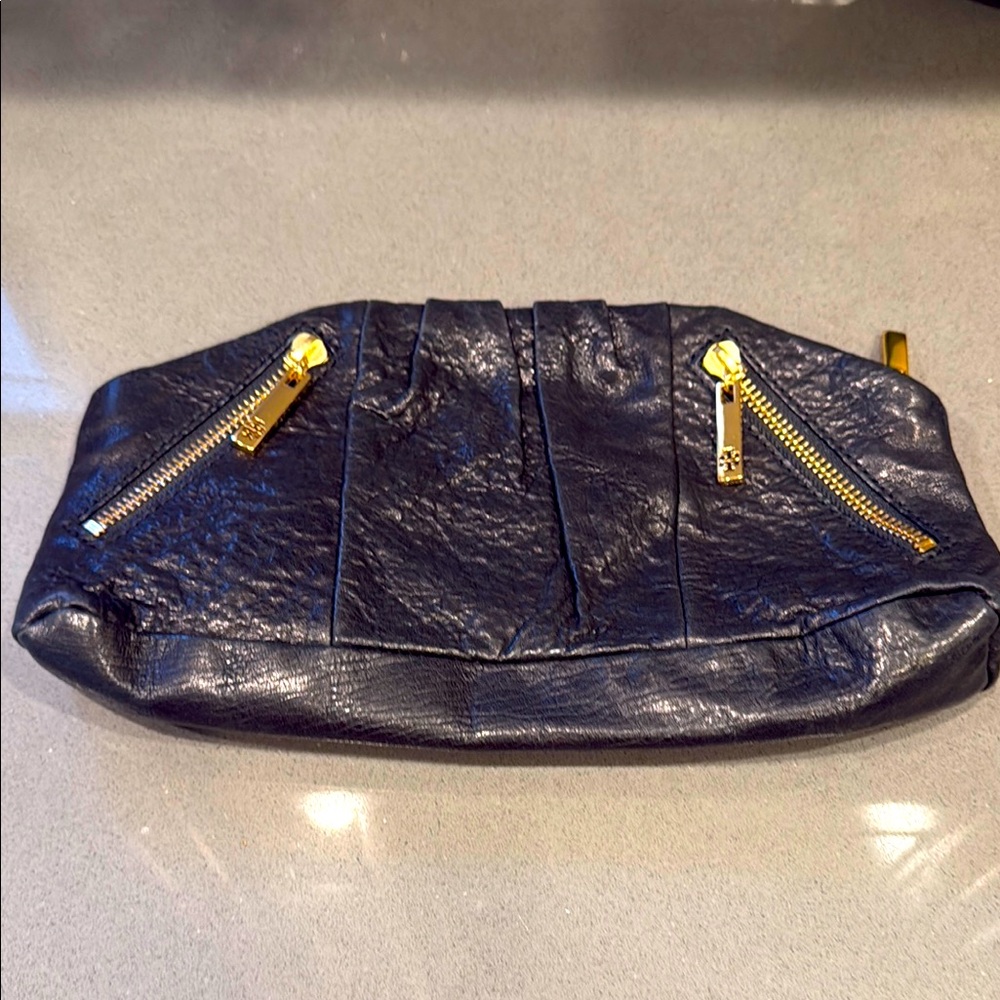 Elegant Black Leather Tory Burch Clutch with Gold Accents